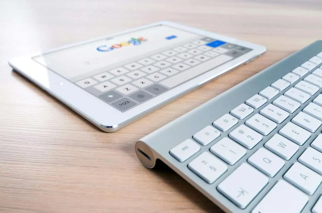 Tablet and keyboard on wooden desk