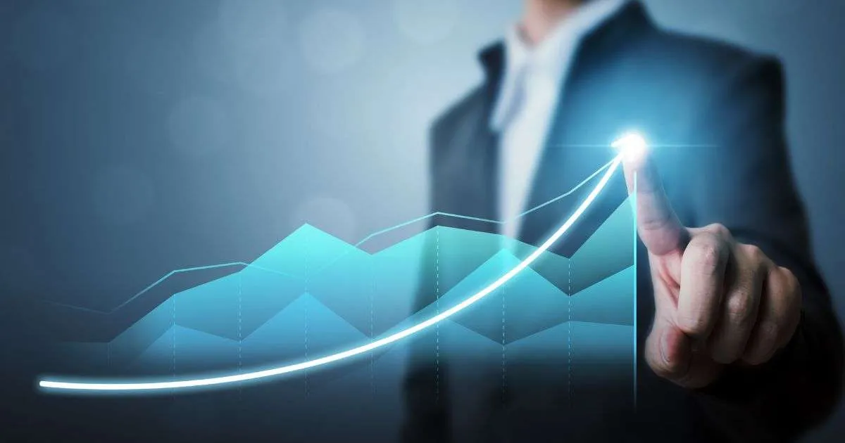 Person points at rising digital graph.
